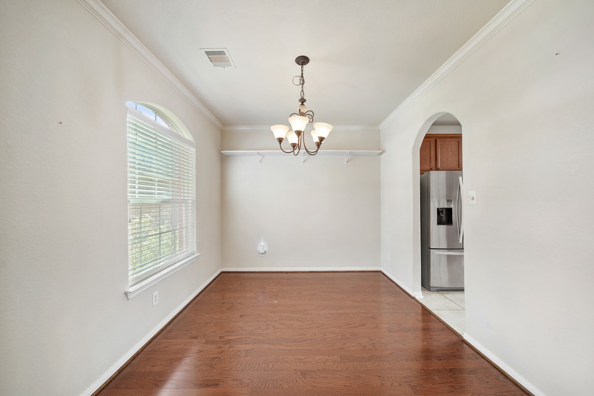 6015 Biltmore Court Rosenberg, TX 77471 - Photo 5 of 31 wooden floor in an empty room with a window