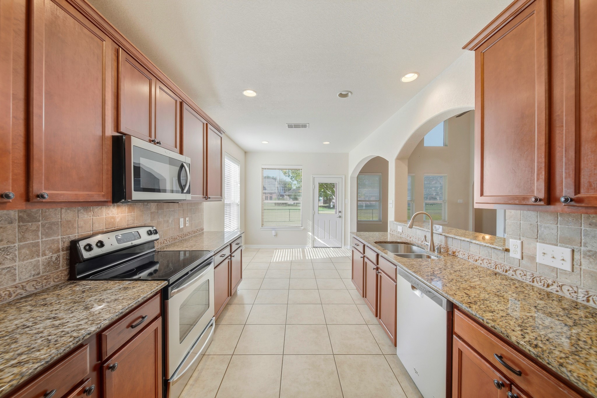 6015 Biltmore Court Rosenberg, TX 77471 - Photo 7 of 31 a large kitchen with stainless steel appliances granite countertop a sink stove and cabinets