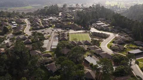 an aerial view of residential house and sandy dunes