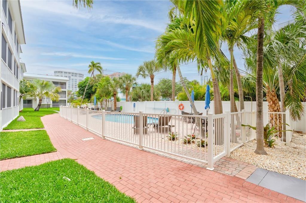 1439 South Ocean Boulevard, Unit 211 Pompano Beach, FL 33062 - Photo 14 of 46 a view of a yard with palm trees