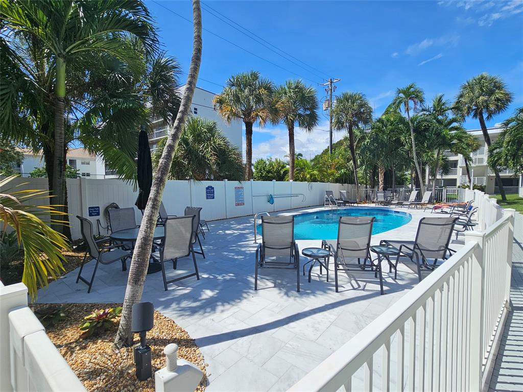 1439 South Ocean Boulevard, Unit 211 Pompano Beach, FL 33062 - Photo 16 of 46 a view of a chairs and table in the patio