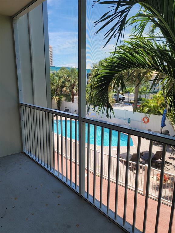 1439 South Ocean Boulevard, Unit 211 Pompano Beach, FL 33062 - Photo 17 of 46 a view of a balcony with a tree
