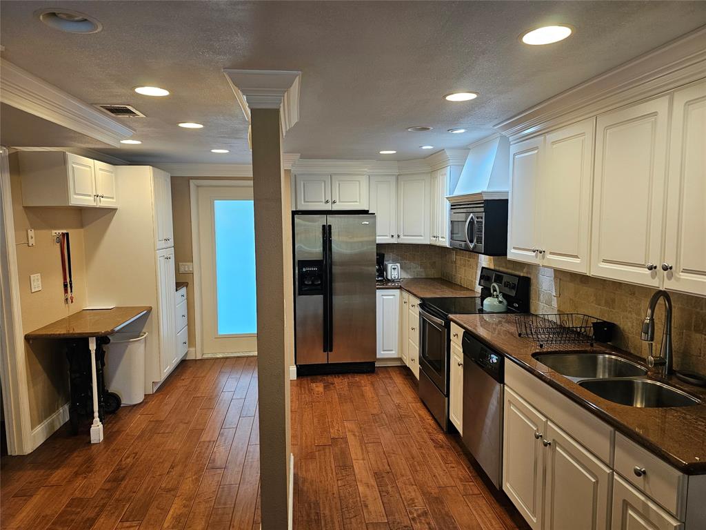 1439 South Ocean Boulevard, Unit 211 Pompano Beach, FL 33062 - Photo 22 of 46 a kitchen with stainless steel appliances granite countertop a refrigerator a sink dishwasher a stove top oven a dining table and chairs with wooden floor