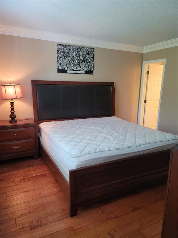 1439 South Ocean Boulevard, Unit 211 Pompano Beach, FL 33062 - Photo 27 of 46 a bedroom with a bed and a night stand