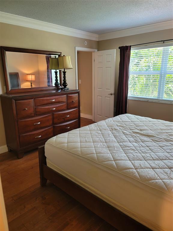 1439 South Ocean Boulevard, Unit 211 Pompano Beach, FL 33062 - Photo 28 of 46 a bedroom with a bed and a large window