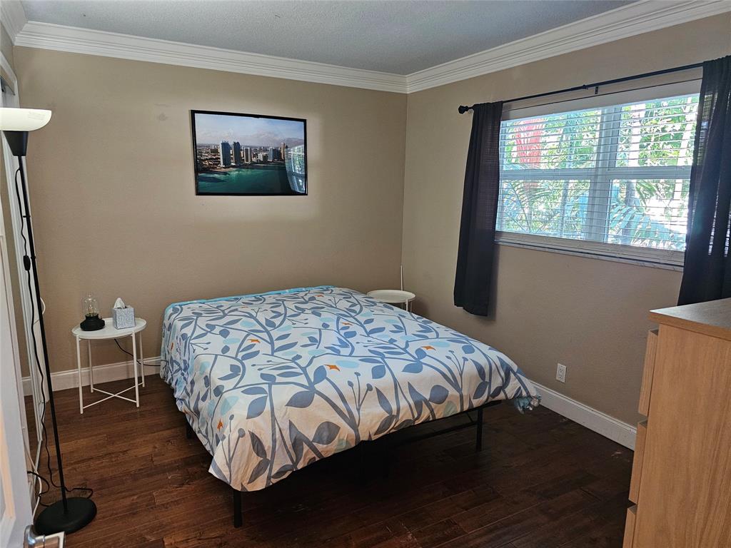 1439 South Ocean Boulevard, Unit 211 Pompano Beach, FL 33062 - Photo 31 of 46 a bedroom with bed and a window