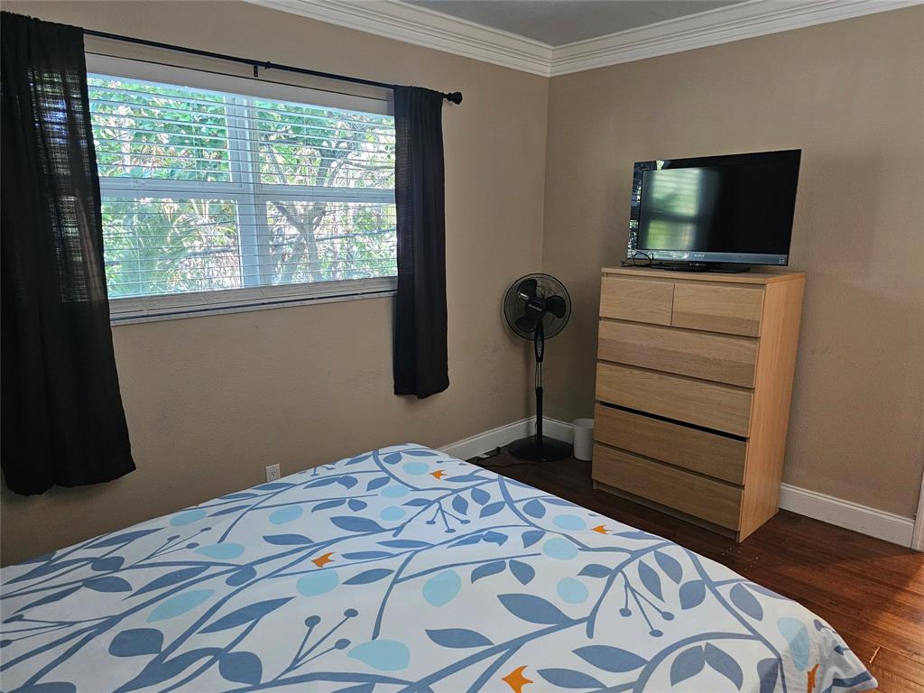 1439 South Ocean Boulevard, Unit 211 Pompano Beach, FL 33062 - Photo 32 of 46 a bedroom with a bed and flat screen tv