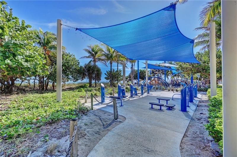 1439 South Ocean Boulevard, Unit 211 Pompano Beach, FL 33062 - Photo 44 of 46 a view of a chairs and table in backyard