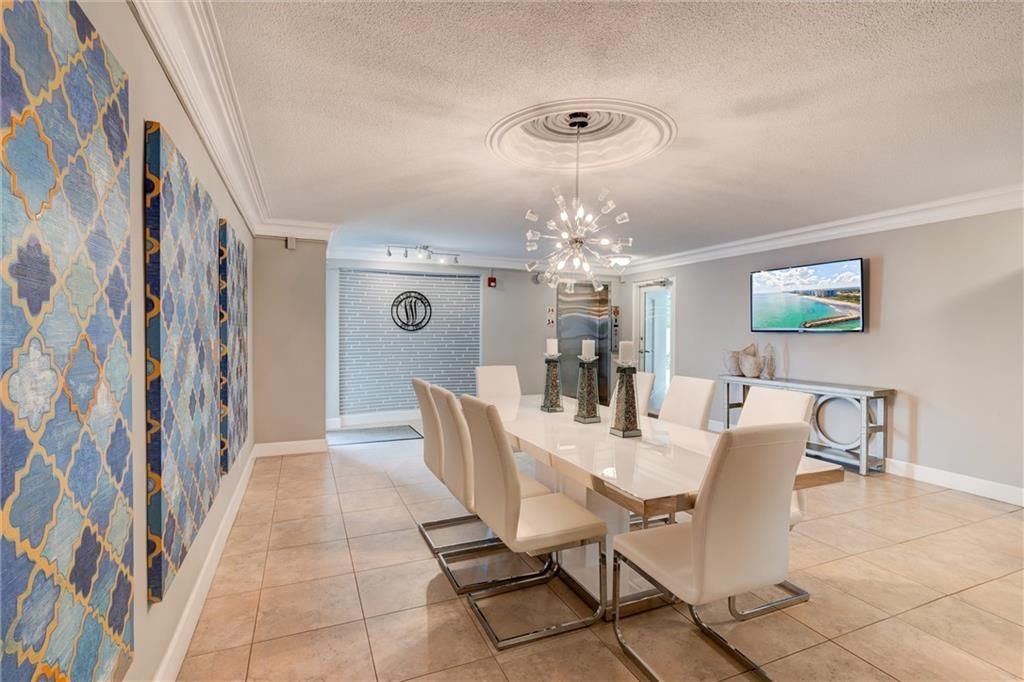 1439 South Ocean Boulevard, Unit 211 Pompano Beach, FL 33062 - Photo 10 of 46 a view of a dining room with furniture and chandelier