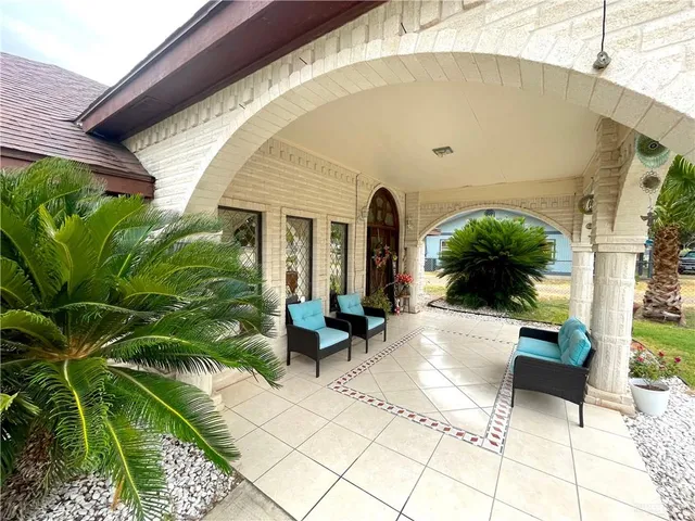a house with green field in front of it