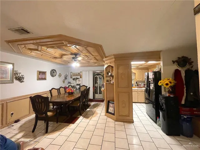 a large white house with a yard and fence