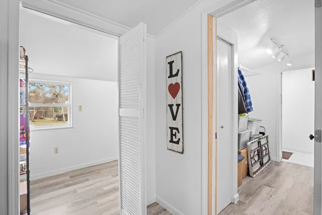 a view of a hallway with paintings on the wall