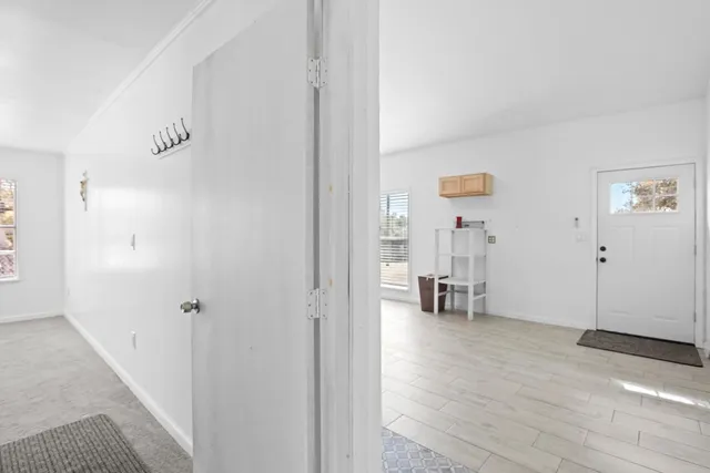 a view of empty room with wooden floor and windows