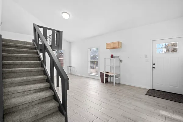 a view of staircase with white walls and wooden floor