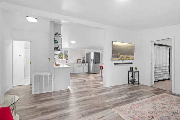 a view of a living room with furniture and flat screen tv