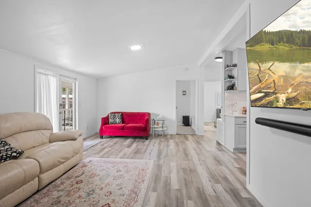 a bedroom with furniture and a wooden floor
