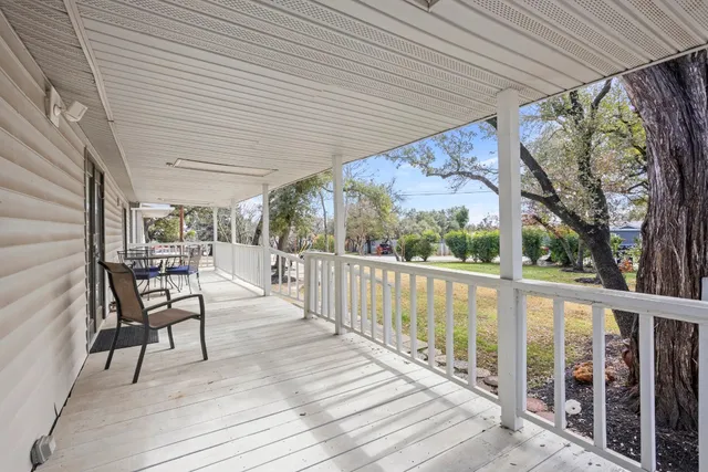 a view of a patio with a table chairs and wooden floor
