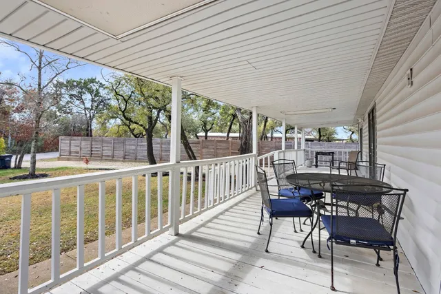 a view of a chairs and table in the balcony