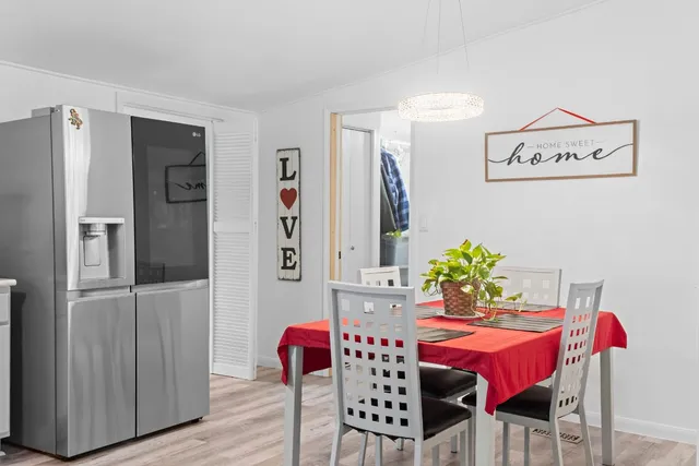 a view of a dining room with furniture and wooden floor