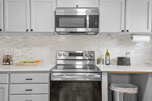 a kitchen with appliances cabinets and a counter top space