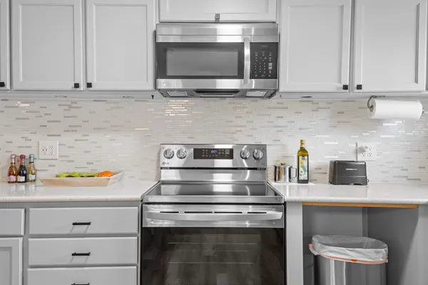 a kitchen with appliances cabinets and a counter top space