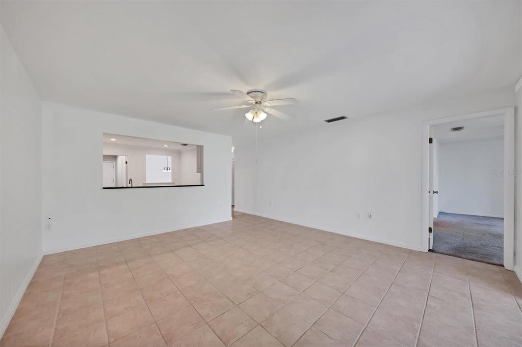 3930 Center Gate Circle, Unit 16 Sarasota, FL 34233 - Photo 14 of 30 a view of an empty room with a ceiling fan