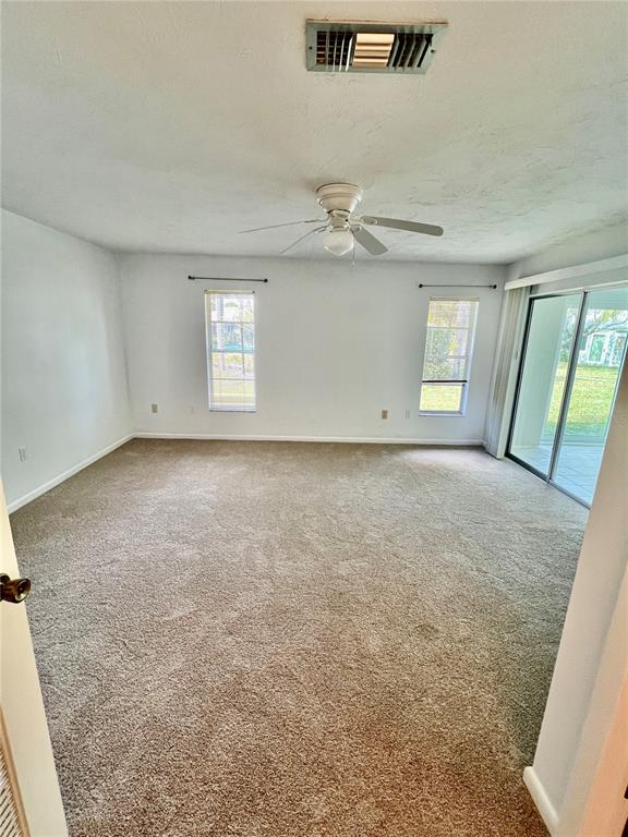 3930 Center Gate Circle, Unit 16 Sarasota, FL 34233 - Photo 18 of 30 wooden floor in an empty room with a window