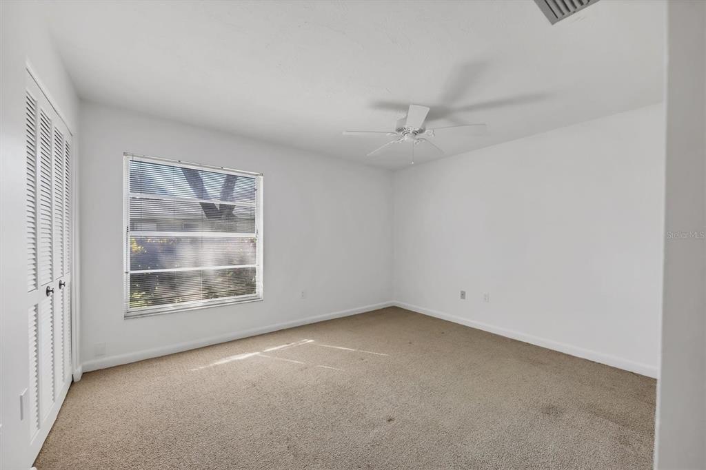 3930 Center Gate Circle, Unit 16 Sarasota, FL 34233 - Photo 21 of 30 an empty room with a empty space and windows