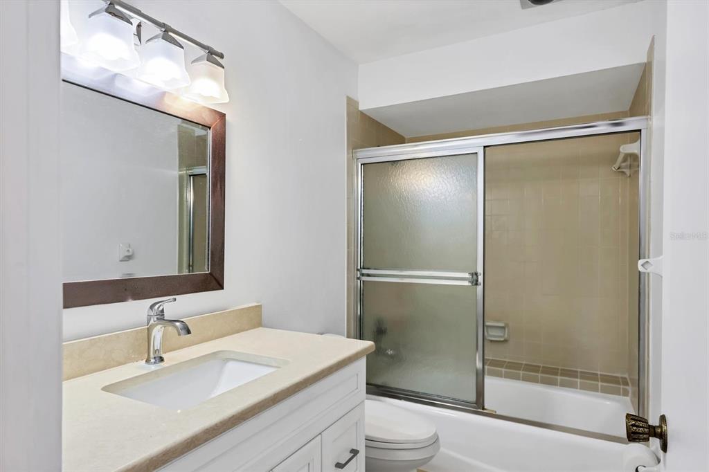 3930 Center Gate Circle, Unit 16 Sarasota, FL 34233 - Photo 23 of 30 a bathroom with a sink toilet and shower