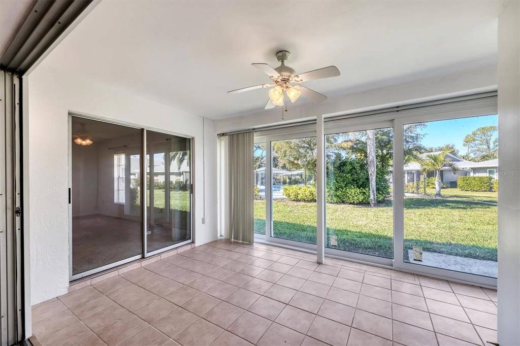 3930 Center Gate Circle, Unit 16 Sarasota, FL 34233 - Photo 26 of 30 a view of an empty room and window ceiling fan