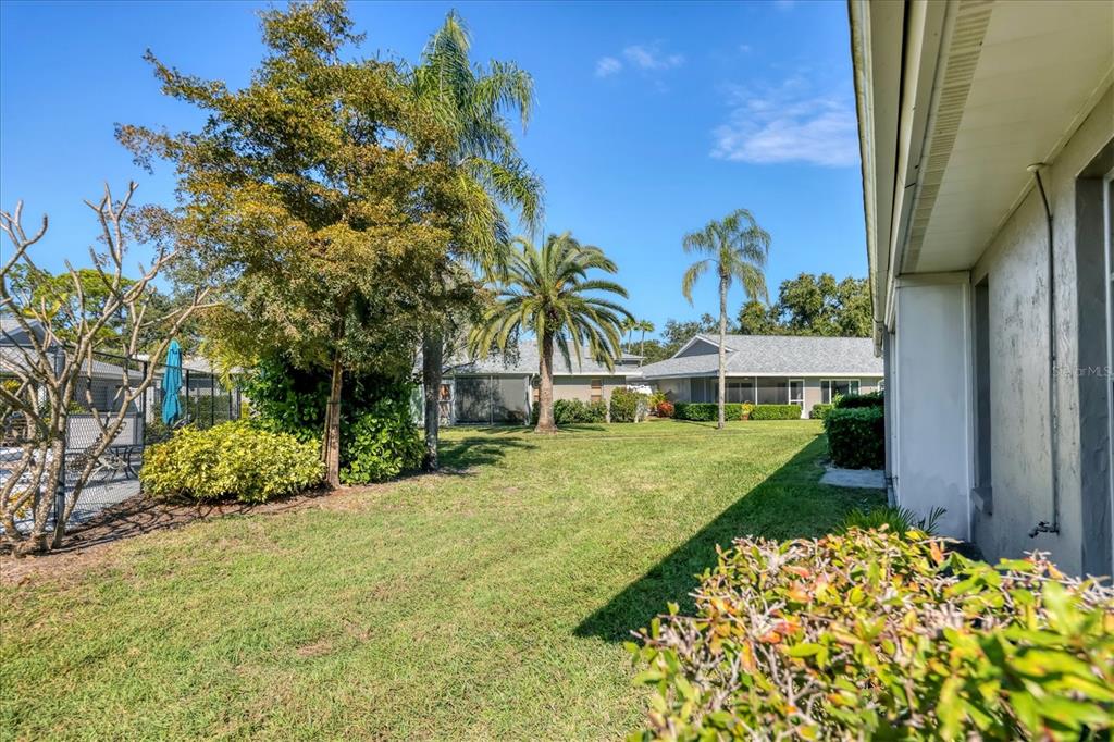 3930 Center Gate Circle, Unit 16 Sarasota, FL 34233 - Photo 27 of 30 a view of backyard with outdoor seating and green space
