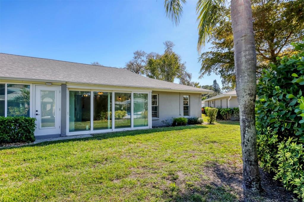 3930 Center Gate Circle, Unit 16 Sarasota, FL 34233 - Photo 28 of 30 a view of a house with a yard and potted plants