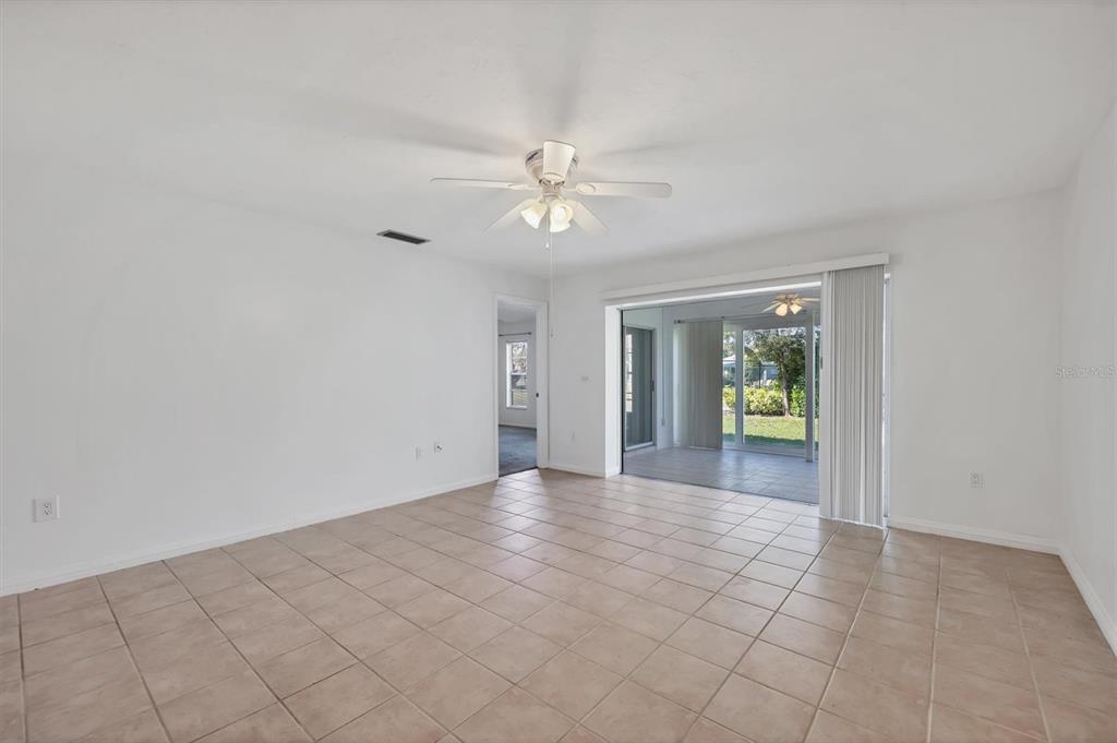 3930 Center Gate Circle, Unit 16 Sarasota, FL 34233 - Photo 8 of 30 an empty room with fan and windows