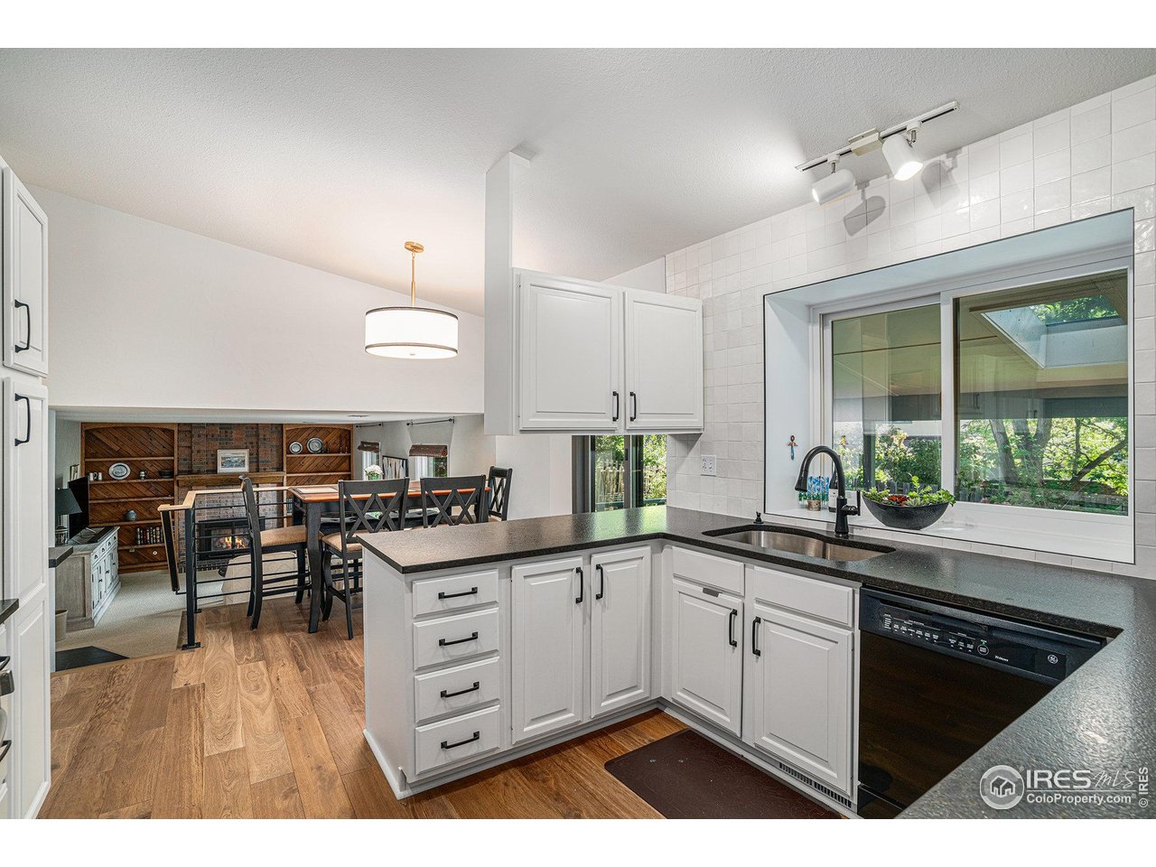 1918 Ridgewood Road Fort Collins, CO 80526 - Photo 7 of 30 Beautifully remodeled kitchen space with open view to second dining room, family room, and patio view. The skylight on the patio provides natural lighting in the box bay window you have to see in person!