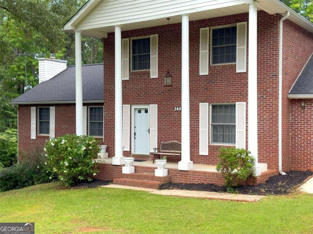 240 Riverview Road Jackson, GA 30233 - Photo 16 of 79 a front view of a house with a yard