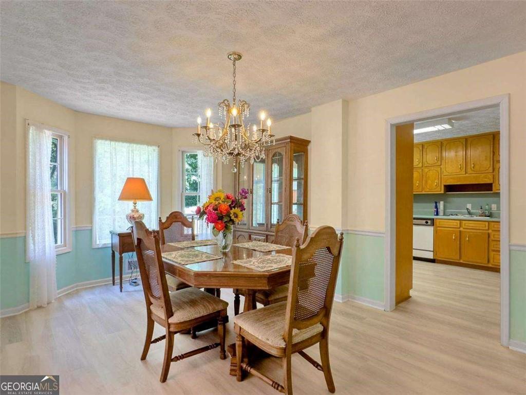 240 Riverview Road Jackson, GA 30233 - Photo 28 of 79 a dining room with furniture a chandelier and wooden floor