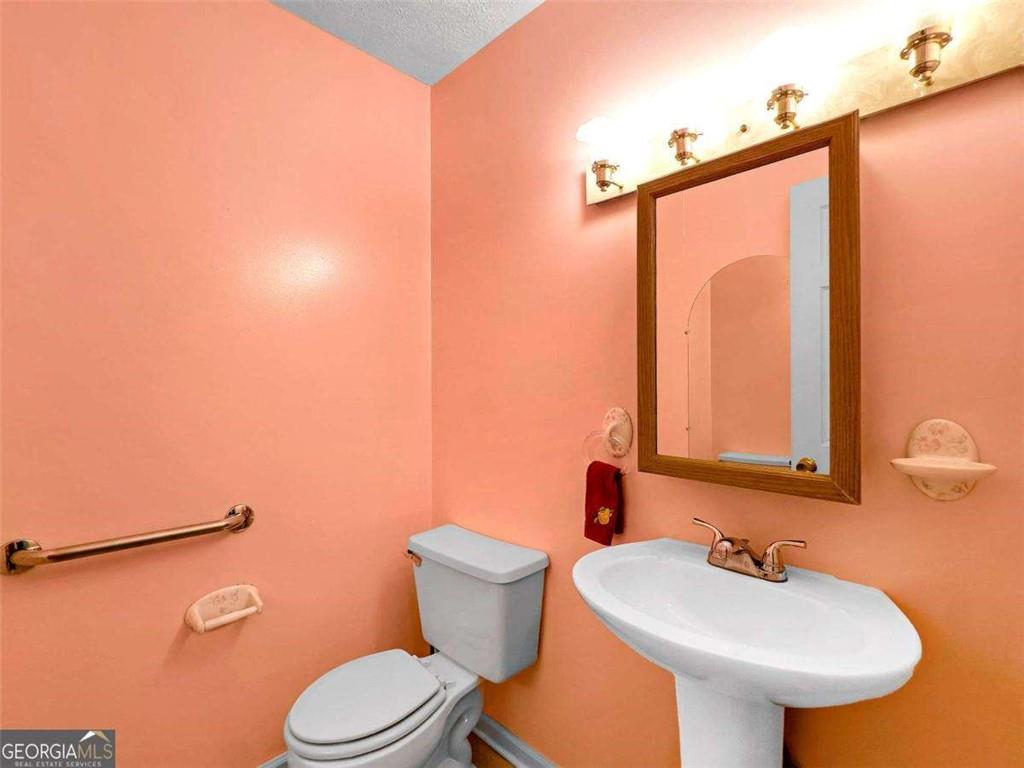 240 Riverview Road Jackson, GA 30233 - Photo 39 of 79 a bathroom with a sink toilet and mirror