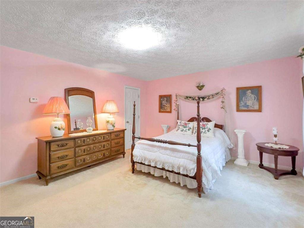 240 Riverview Road Jackson, GA 30233 - Photo 49 of 79 a bed room with a bed and a lamp on table