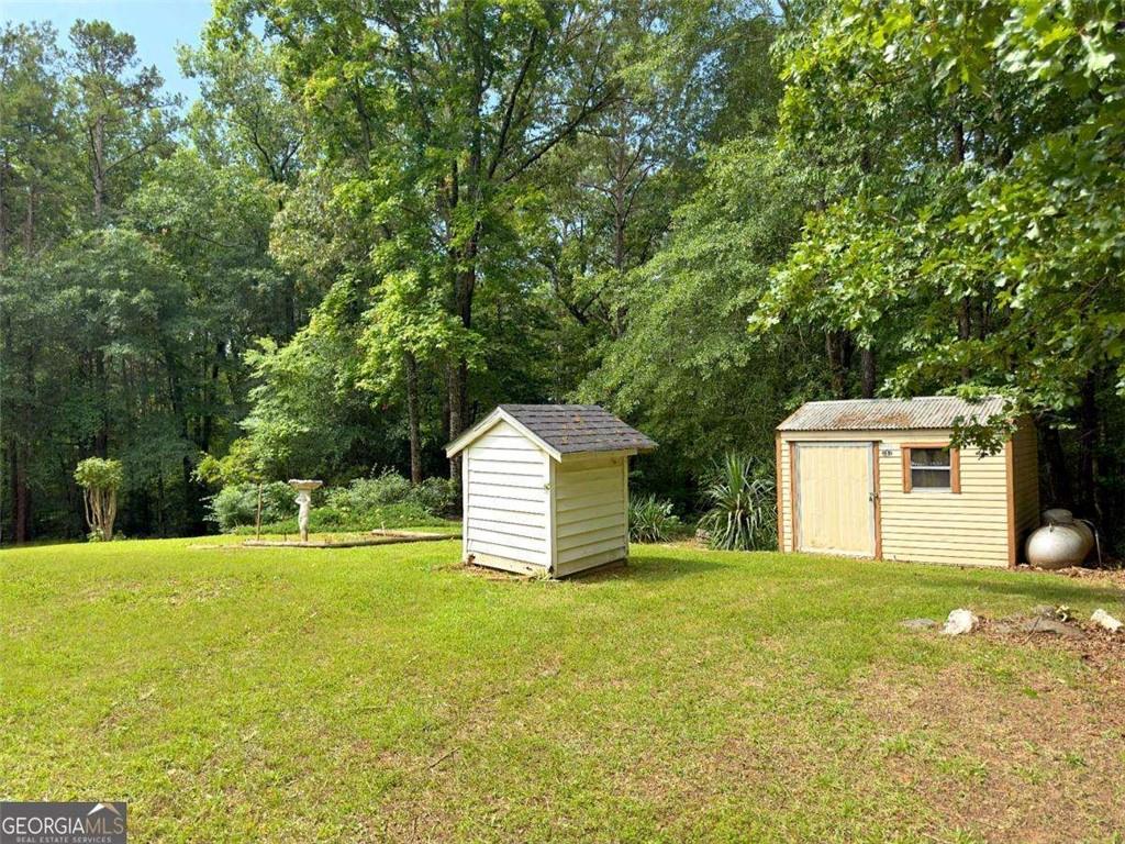 240 Riverview Road Jackson, GA 30233 - Photo 76 of 79 a view of a house with a backyard and a tree