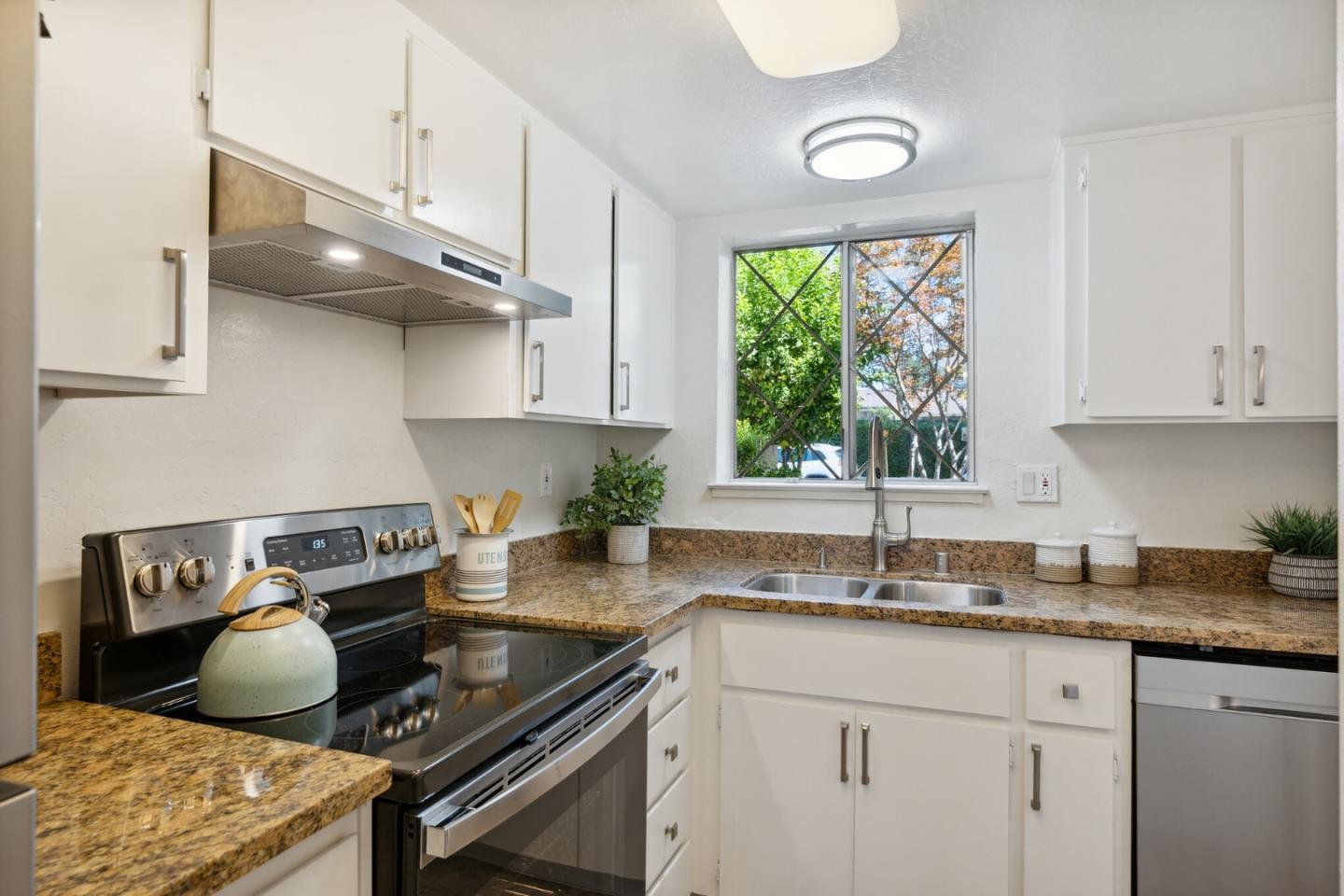 101 Redding Road, Unit B2 Campbell, CA 95008 - Photo 11 of 32 a kitchen with stainless steel appliances granite countertop a sink a stove and a wooden floors