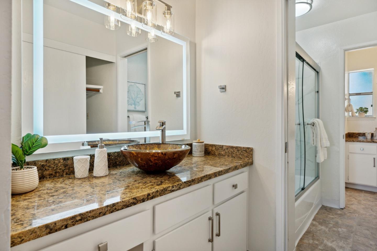 101 Redding Road, Unit B2 Campbell, CA 95008 - Photo 22 of 32 a bathroom with a granite countertop sink and a mirror