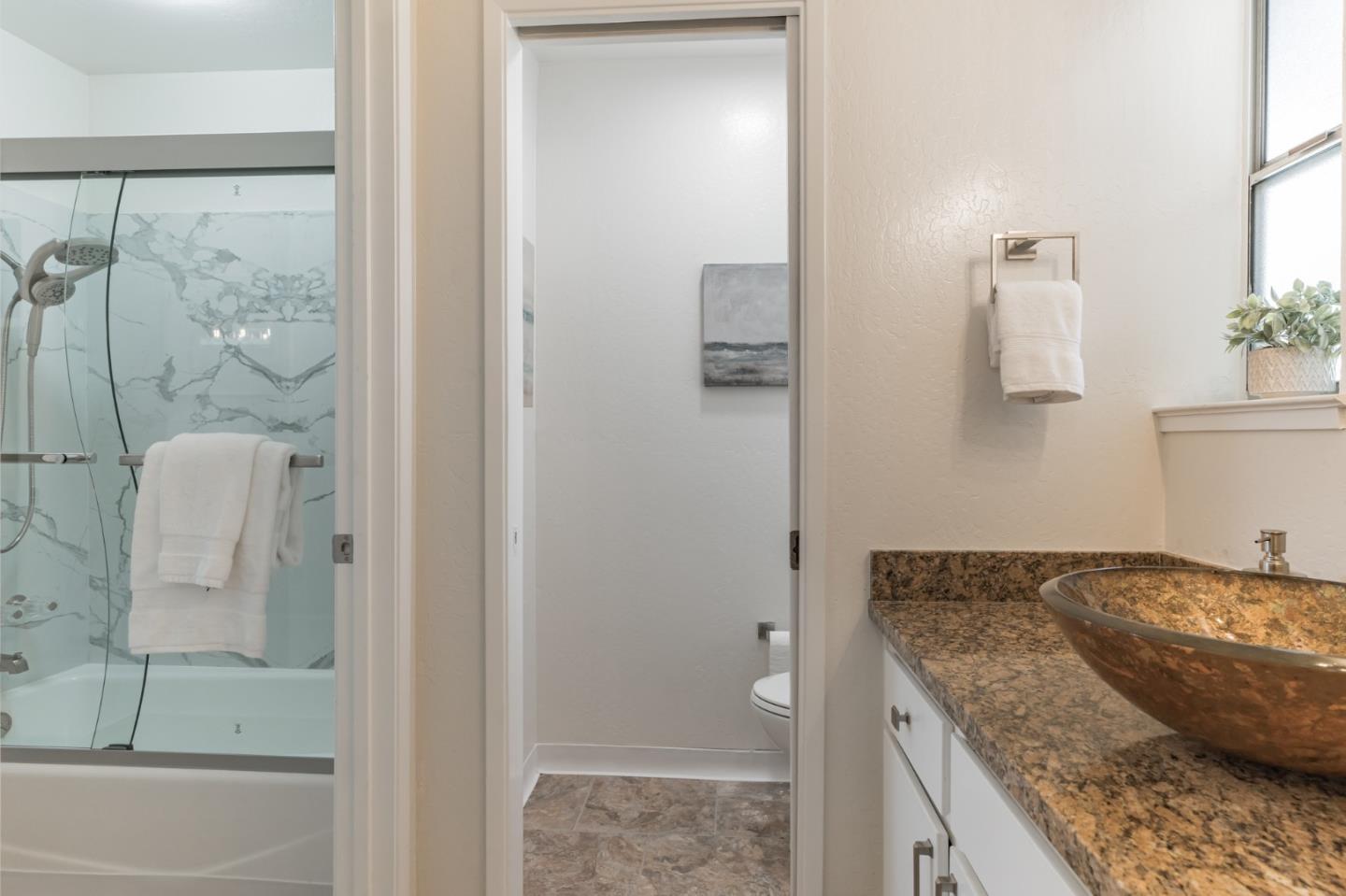 101 Redding Road, Unit B2 Campbell, CA 95008 - Photo 25 of 32 a bathroom with a granite countertop sink and a mirror