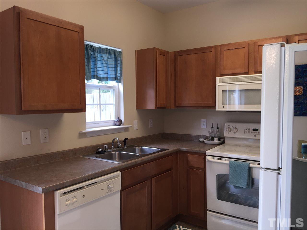 2136 Persimmon Ridge Drive Raleigh, NC 27604 - Photo 11 of 23 a kitchen with stainless steel appliances granite countertop a sink stove and microwave