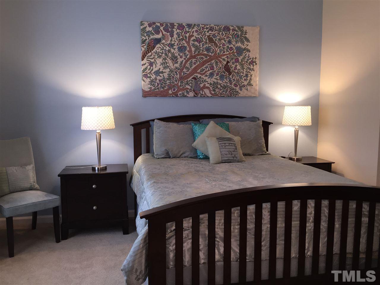 2136 Persimmon Ridge Drive Raleigh, NC 27604 - Photo 14 of 23 a bedroom with a bed and a lamp