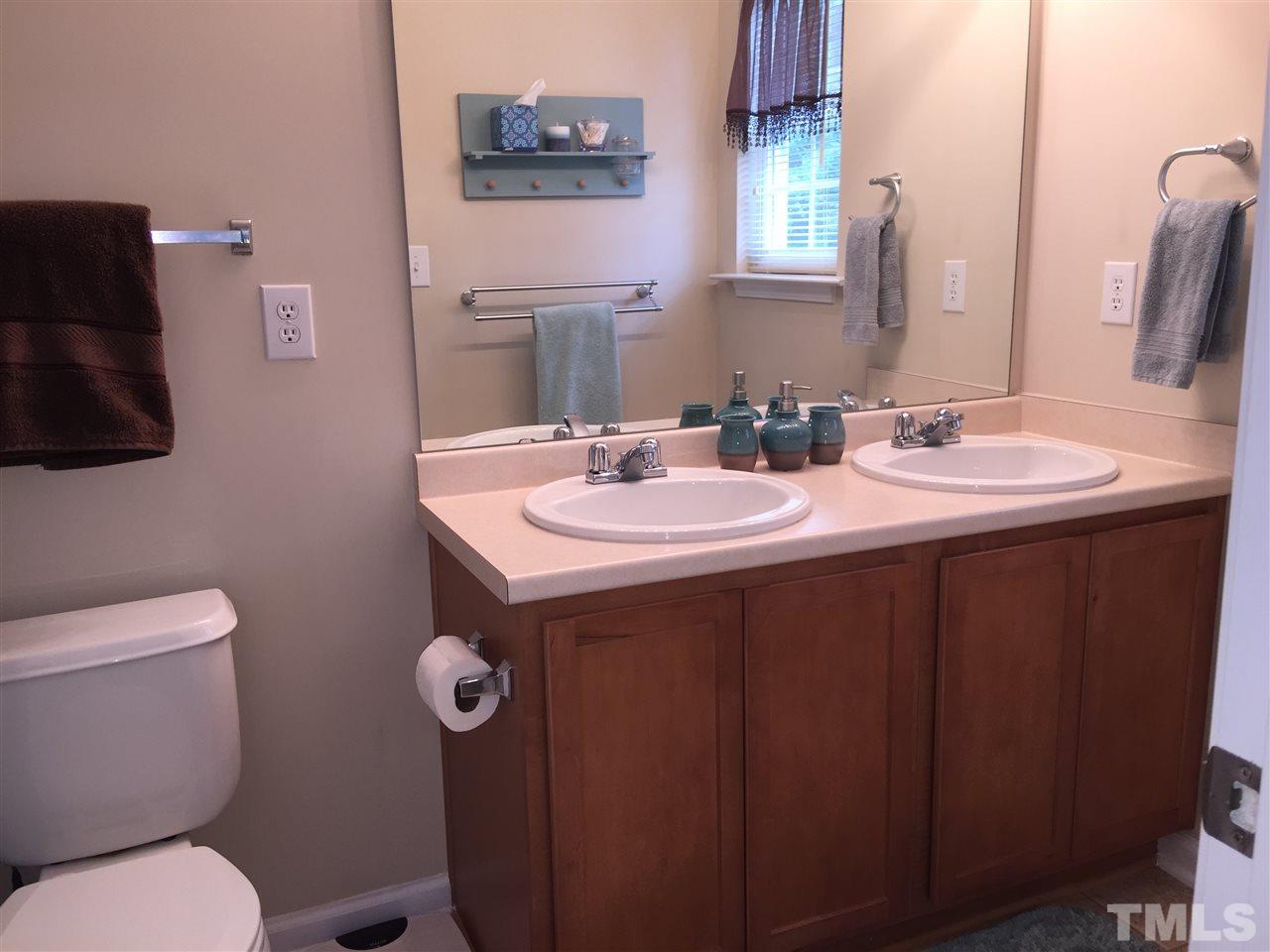 2136 Persimmon Ridge Drive Raleigh, NC 27604 - Photo 15 of 23 a bathroom with a toilet sink and mirror