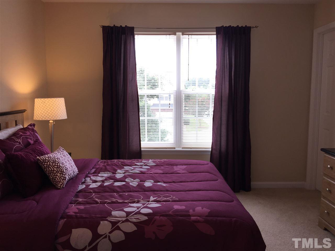 2136 Persimmon Ridge Drive Raleigh, NC 27604 - Photo 18 of 23 a bedroom with a large bed and a window