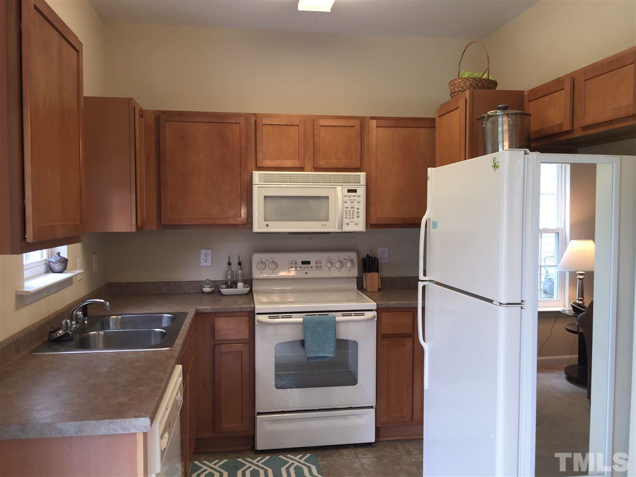 2136 Persimmon Ridge Drive Raleigh, NC 27604 - Photo 10 of 23 a kitchen with a refrigerator sink and stove