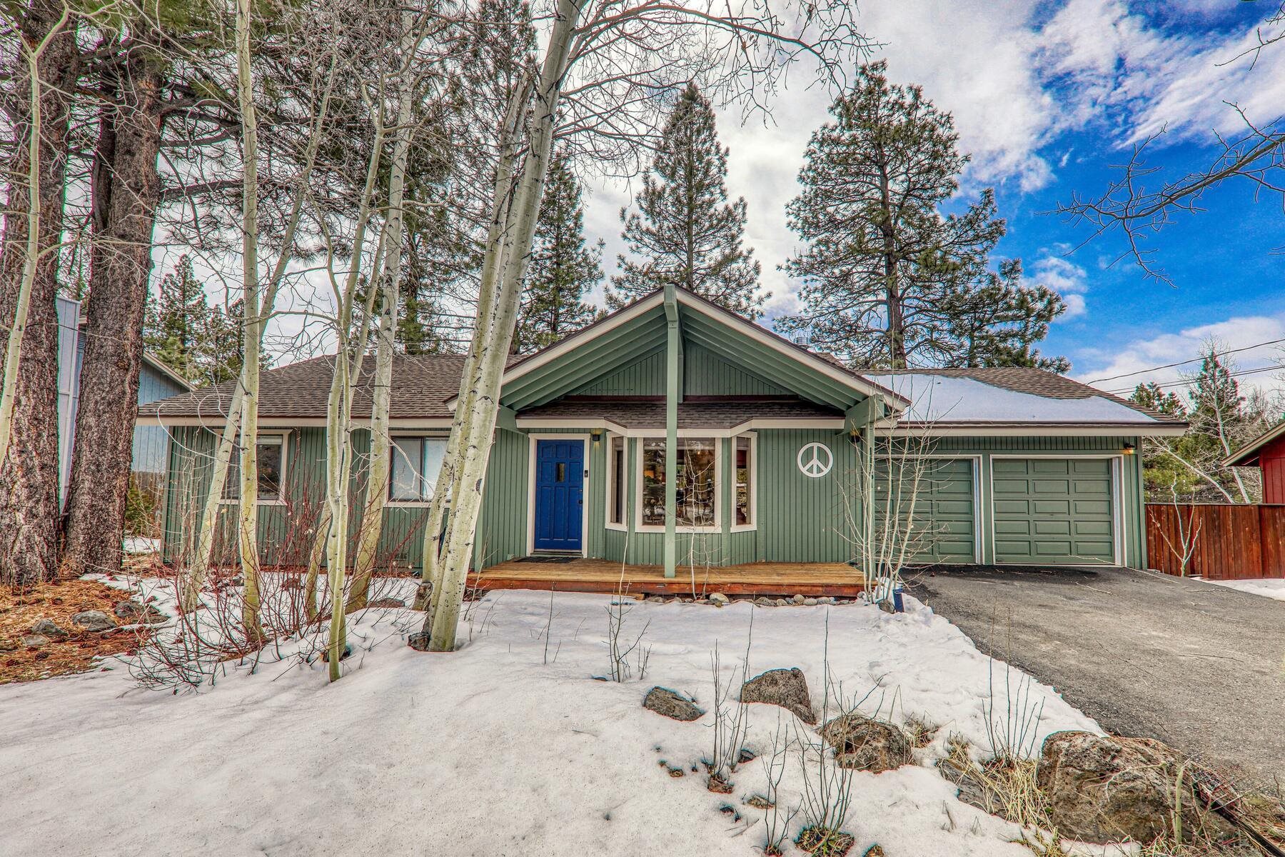 a front view of a house with a yard covered in snow