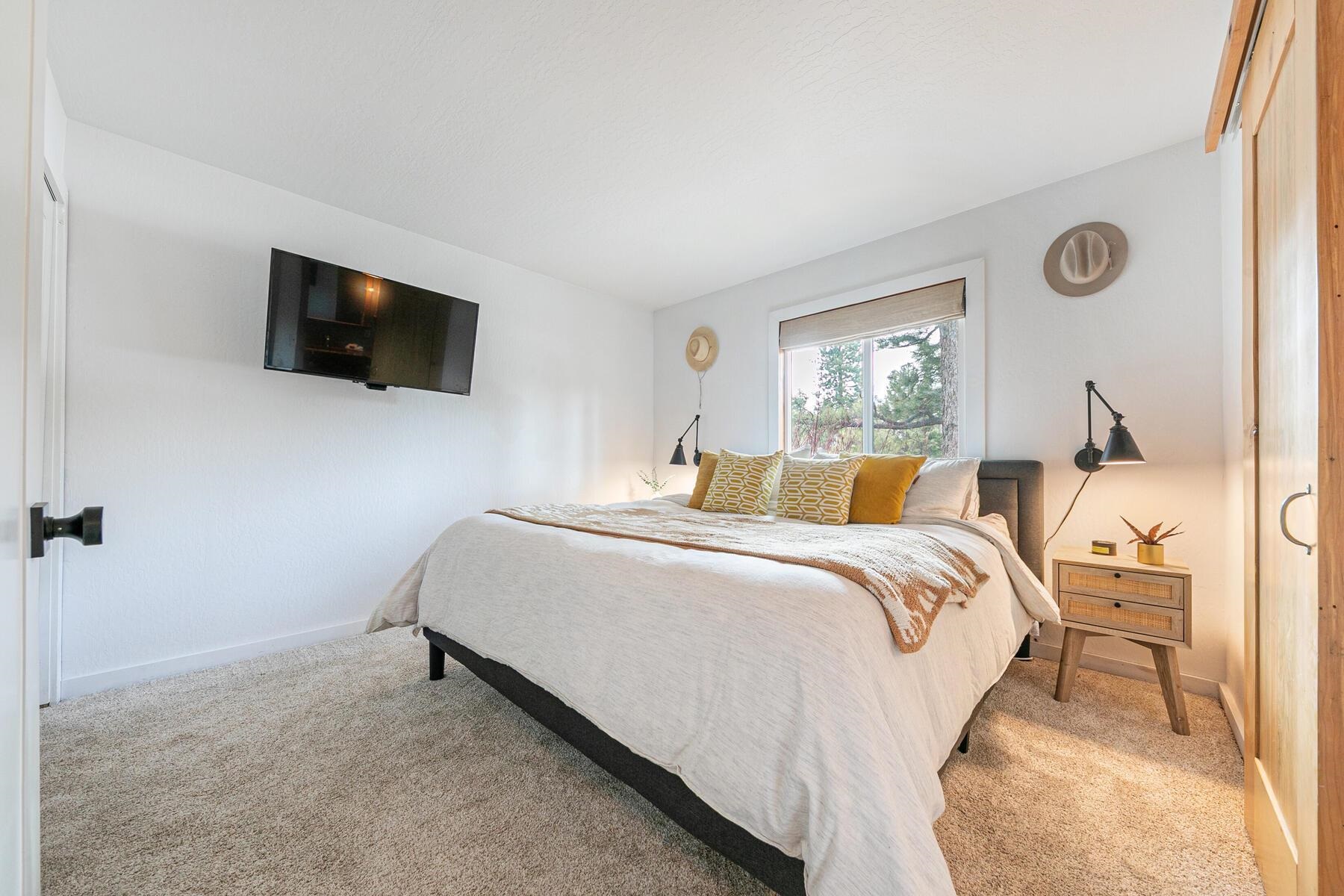 11151 Dorchester Drive Truckee, CA 96161 - Photo 13 of 27 a bedroom with a bed and a flat screen tv