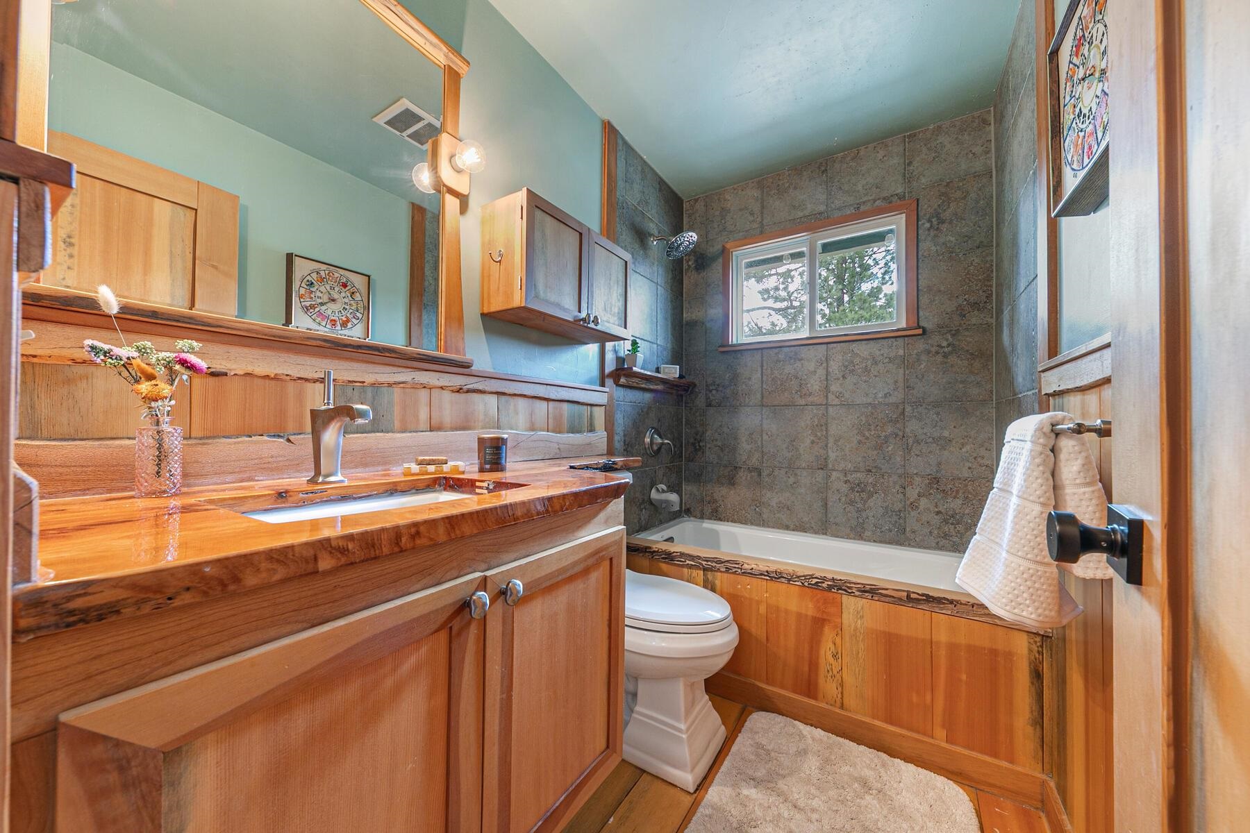11151 Dorchester Drive Truckee, CA 96161 - Photo 18 of 27 a bathroom with a sink a toilet a mirror and bathtub